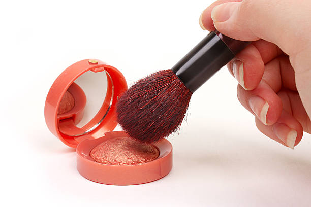 istock Rouge and applicator brush in a hand 176844873