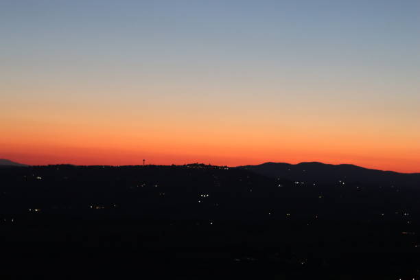Golden sunset sky over dark countryside