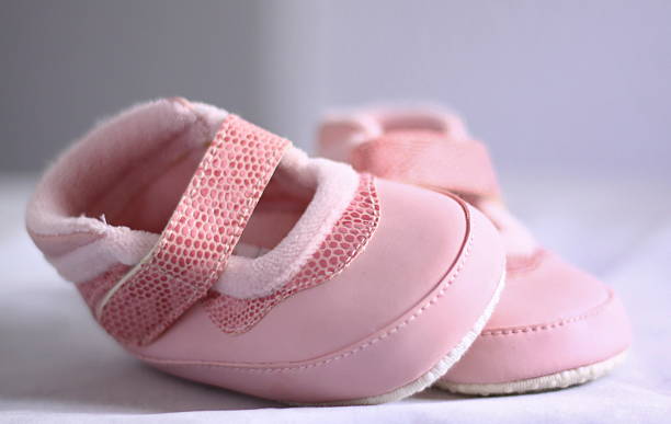 pink baby shoes stock photo