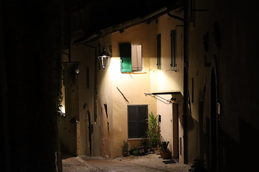 View along a narrow back street in an old town at night