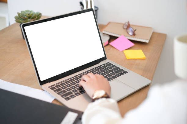 istock Woman had using laptop white screen and stationery on the table in house. 1768461785