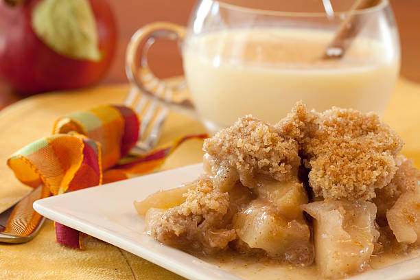 Dish Of Apple Crisp with Whipped Cream Topping and Eggnog stock photo