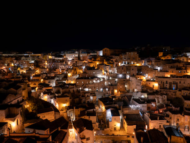 Matera, Italy. Amazing view of the Sassi of Matera at night. Landscape of the historical part of the town. An Unesco World Heritage Site. Touristic destination stock photo