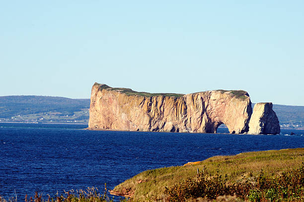 istock Orange pierced rock on a blue sea 176846399