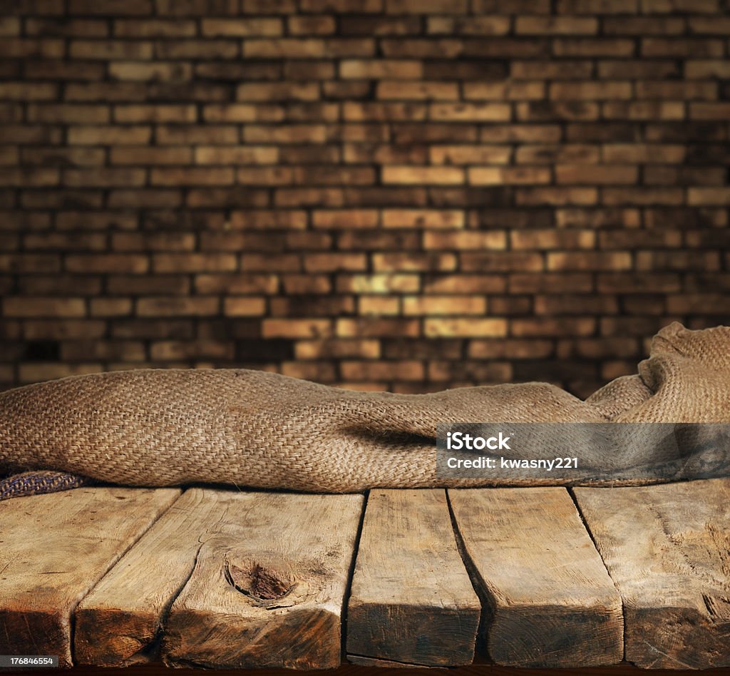 Empty wood table with brick backdrop Empty wooden table for product display montages Abstract Stock Photo