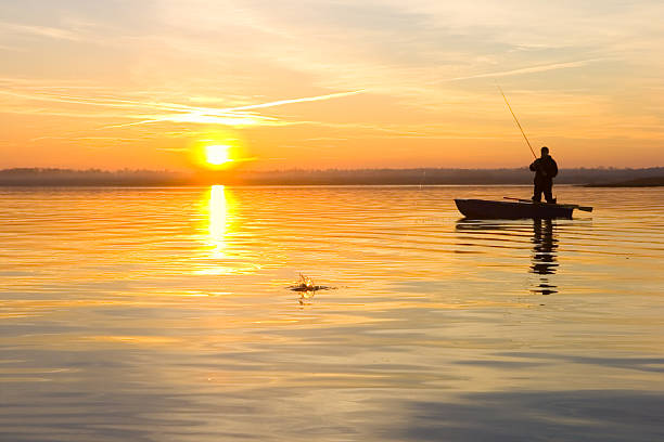 istock Fisherman on a boat at sunset 176846609