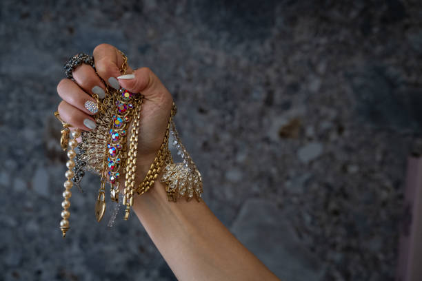 istock Hand with fake cheap jewelry 1768466268