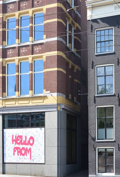 istock Large brown building with multiple windows and an advertisement on the side 1768469697