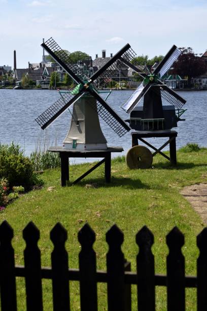 istock two windmills in front of a lake in the background 1768470247