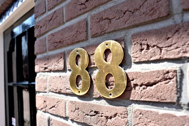 Wall in a brick building with a painted number 88 on it