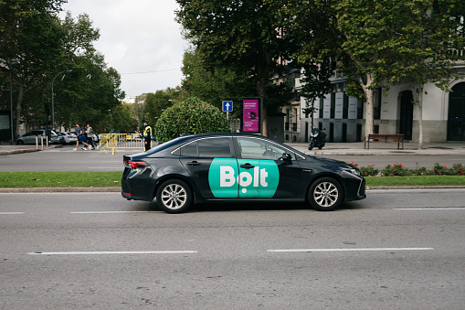 Madrid, Spain - 28 October, 2023: A Toyota Corolla from Bolt, a ride-hailing company, in a street of Madrid, Spain