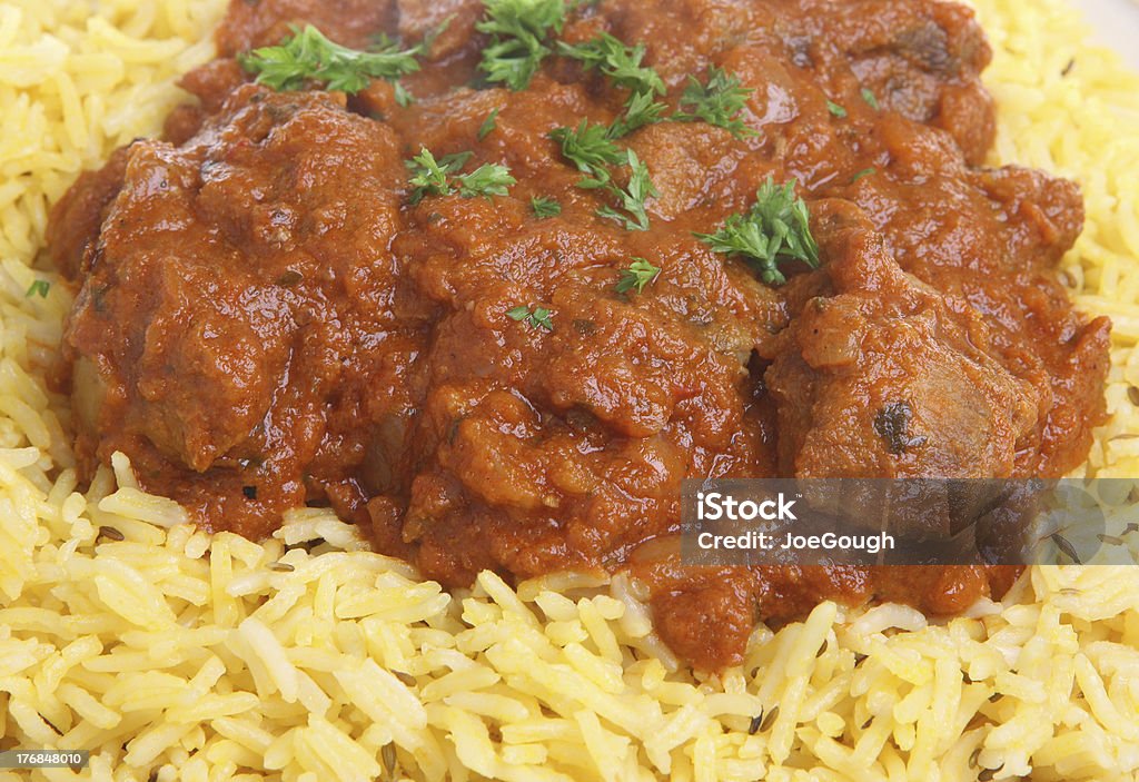 Lamb Rogan Josh Indian Curry Lamb rogan josh Indian curry with pilau rice. Basmati Rice Stock Photo