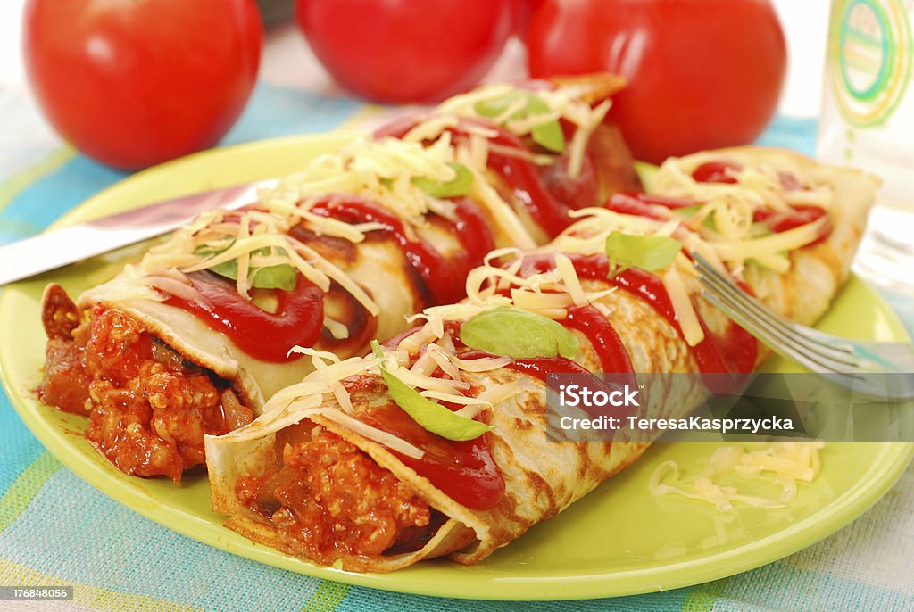 pancakes with bolognese filling two rolled pancakes with minced meat and vegetables filling in bolognese sauce Pancake Stock Photo