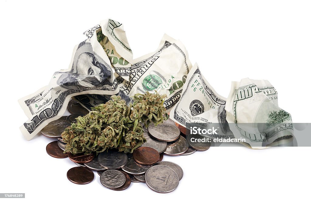 Marijuana, Change and Cash "A high grade hydroponic Cannabis (Marijuana) bud resting on a pile of various USA coins - pennies, quarters, dimes, nickels, and crunpled 100 US$ money notes. White background." Green Color Stock Photo