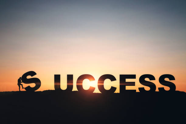 istock Tiny businesspeople putting backlit success letters together on sunset sky backdrop with mock up place. Teamwork, challenge and positive idea concept. 1768484803