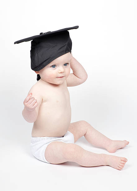 Young boy wearing graduation cap stock photo