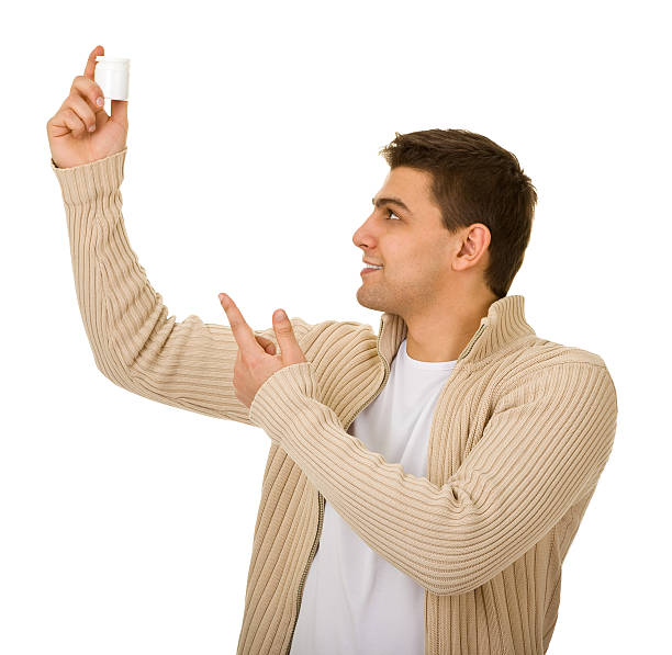 istock man holding a bottle of medicine 176848775