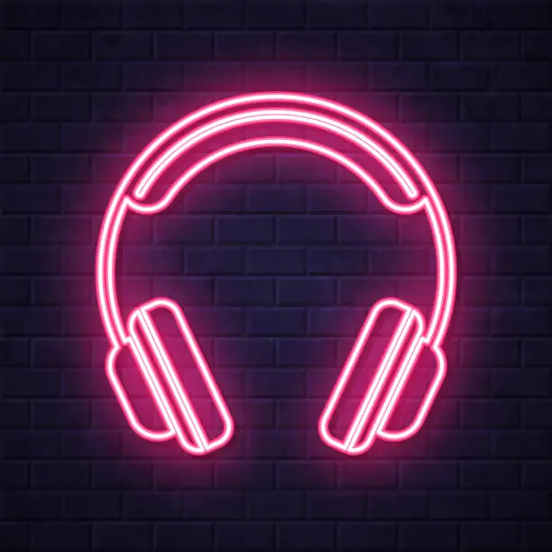 Vector illustration of Headphones. Glowing neon icon on brick wall background