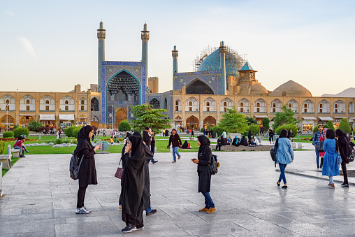 Isfahan, Iran - 24 October, 2018: Awesome view of Naqsh-e Jahan Square and the Shah Mosque (Imam Mosque). The Muslim place is a popular tourist attraction of the Middle East. Persian architecture.