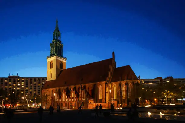 Fantastic view on Church St.Marienkirche  and blue sky of twilights of Berlin. Blurred motion people of long exposure
 - downtown of German capital