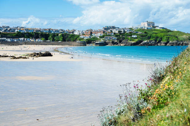 istock Newquay beach with blue sea, stone cliffs and white sand in Cornwall 1768490816