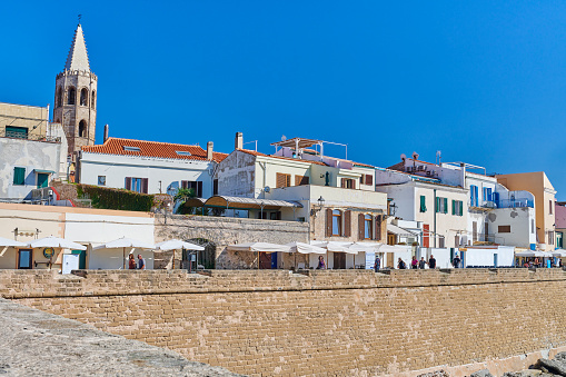 Alghero, Italy - October 1, 2023:tourists enjoying a walk on Marco Polo Bastions on a sunny day of fall.