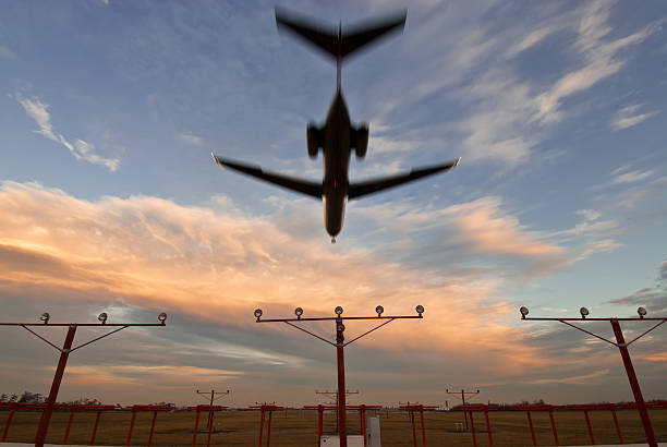 istock Overhead Airliner Landing at Sunset 176849545