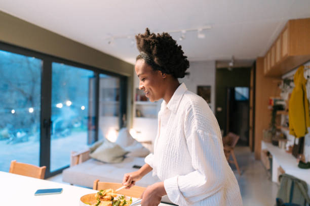 istock Young woman serving a delicious dinner 1768497005