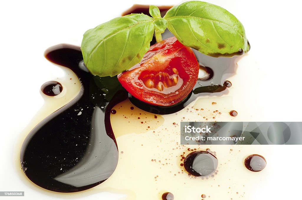 slice tomato and basil slice tomato and basil  over olive oil and balsamic vinegar on white background Balsamic Vinegar Stock Photo