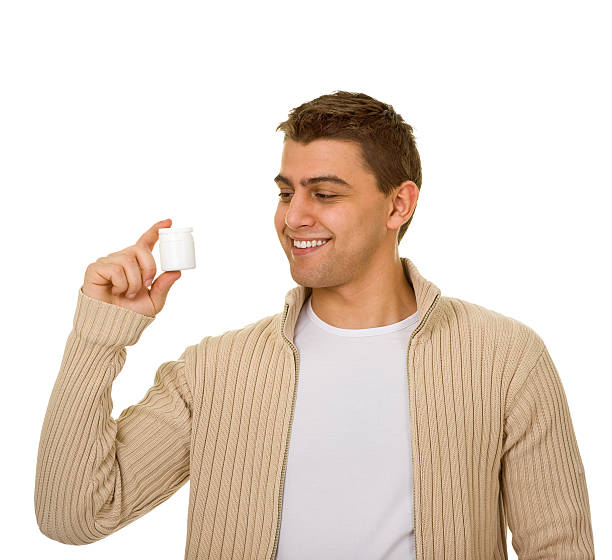 istock man holding a bottle of medicine 176850503