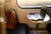 Laptop in train on the table by the window. Business trip