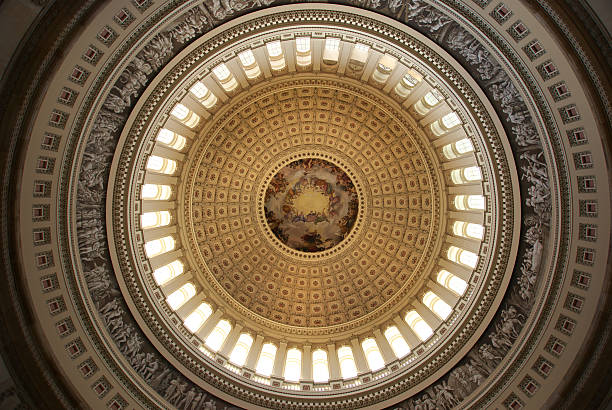 The Apotheosis of Washington The Apotheosis of Washington is the immense fresco painted by Italian artist Constantino Brumidi in 1865 and visible through the oculus of the dome in the rotunda of the United States Capitol Building.Please refer to Wikipedia for details: http://en.wikipedia.org/wiki/The_Apotheosis_of_Washington rotunda stock pictures, royalty-free photos & images