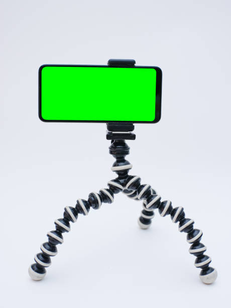 istock smartphone with green screen on tripod holder. smartphone mock up with chroma key 1768516782