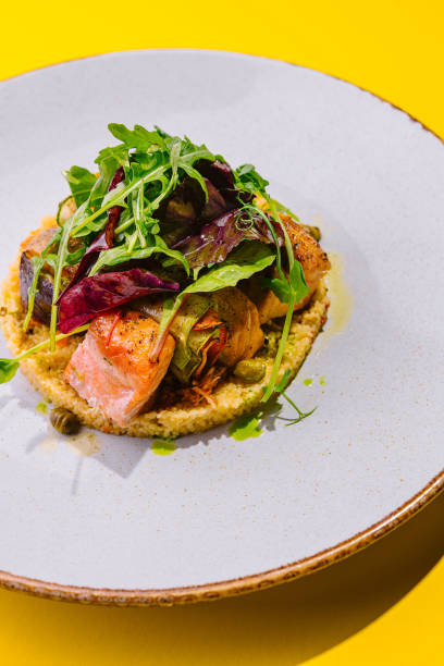 istock fried salmon with cous cous and arugula 1768517326