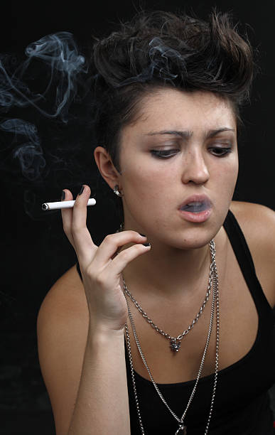 istock woman smoking a cigarette 176852026
