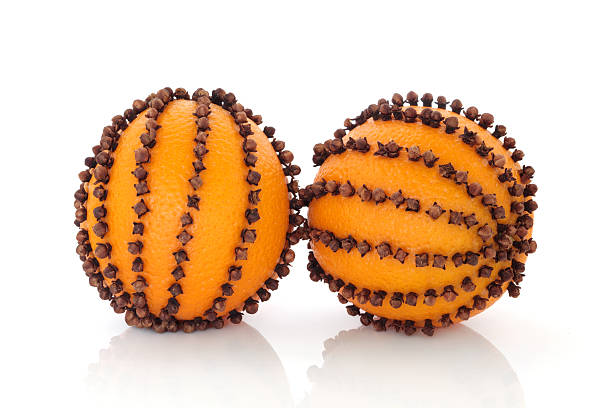 Orange Pomanders Christmas pomander clove and orange  fruit isolated over white background. scent container stock pictures, royalty-free photos & images