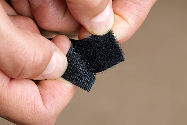 Velcro fastener Close up of hand opening a velcro fastener nylon fastening tape stock pictures, royalty-free photos & images