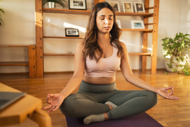 istock Latin woman meditating at home 1768522441
