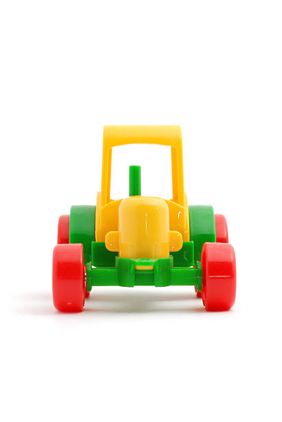 istock Small toy tractor isolated on white 176852546
