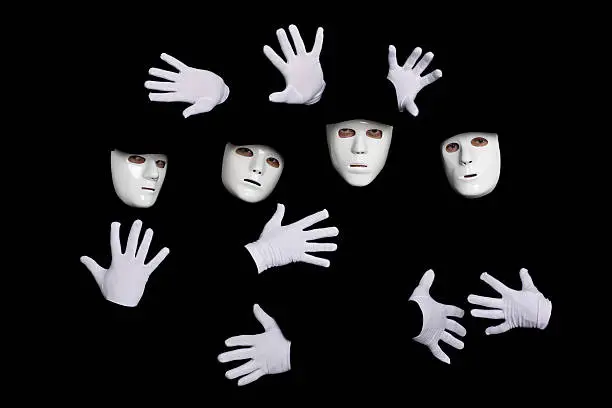 Portrait of a team of young break dancers in masks on a black background.
