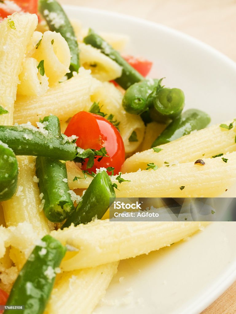 Pens Italian pasta penne with cherry tomatoes and green beans. Shallow dof. Appetizer Stock Photo