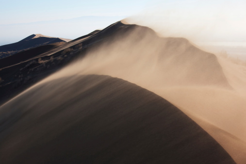 The desert sprawls infinitely, its golden sands complemented by the brilliance of the azure sky.