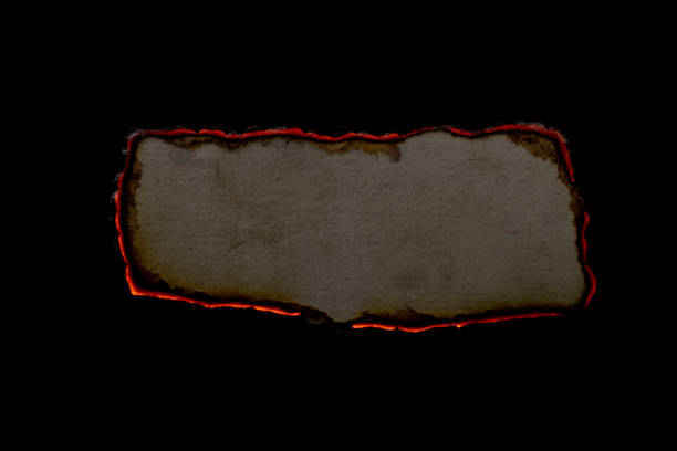 burning paper, glowing edge of paper on a black background