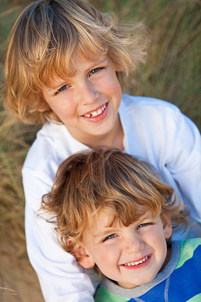 istock Two Little Boys, Brothers, Together on A Sunny Beach 176853552