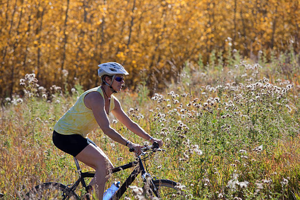 Senior woman riding mountain bike. stock photo