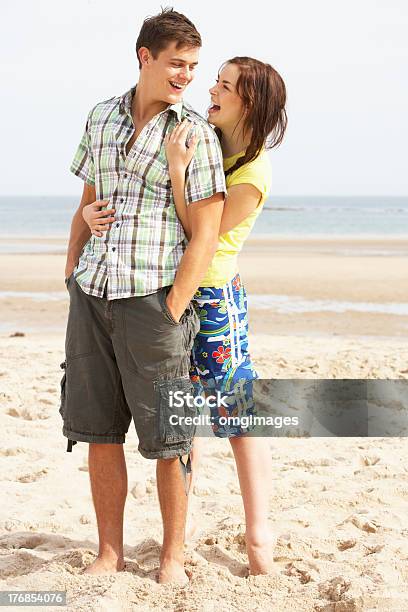 Romantic Teenage Couple Embracing On Beach Stock Photo - Download Image Now - Adult, Affectionate, Beach