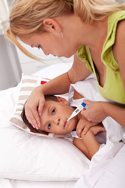 istock Woman checking little boy's temperature 176854721