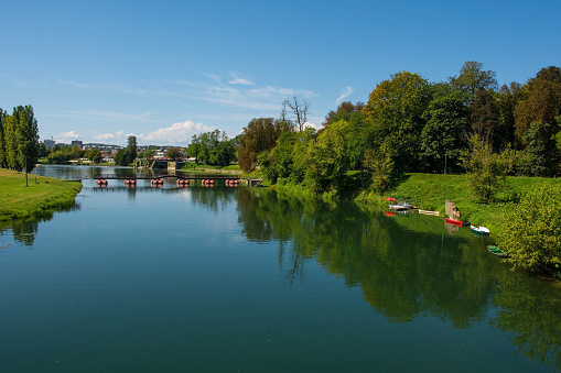 Pjesacki Pontonski Most bridge crosses the Korana River as it passes through the town of Karlovac in central Croatia