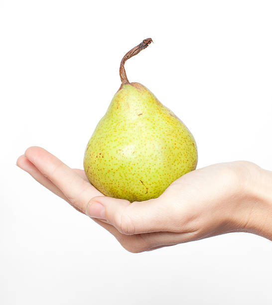 Hand holding a pear stock photo