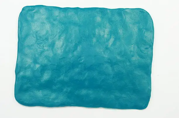 "A simple plasticine celadon (sea-green)  background.  It is a flattened piece of plasticine with your fingers. This background may be used, for example, as background for the labels bright letters."
